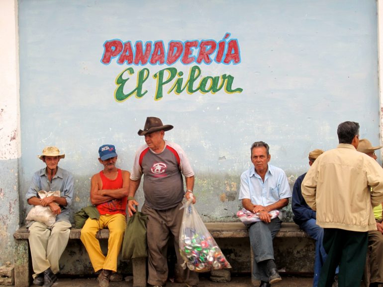 Cycling Cuba: Men in front of a shop