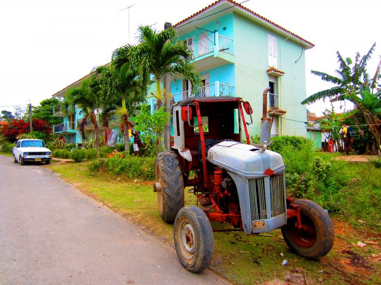 Cycling Cuba: House, tractor and car on the road