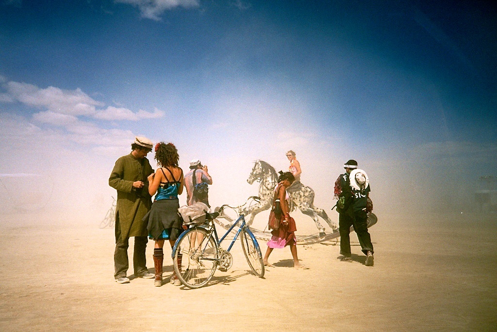 Festivals around the world: People and a toy horse in the desert