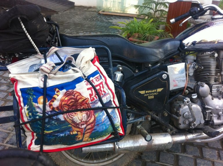 Renting an Enfield in India: Indian bag strapped to a Royal Enfield