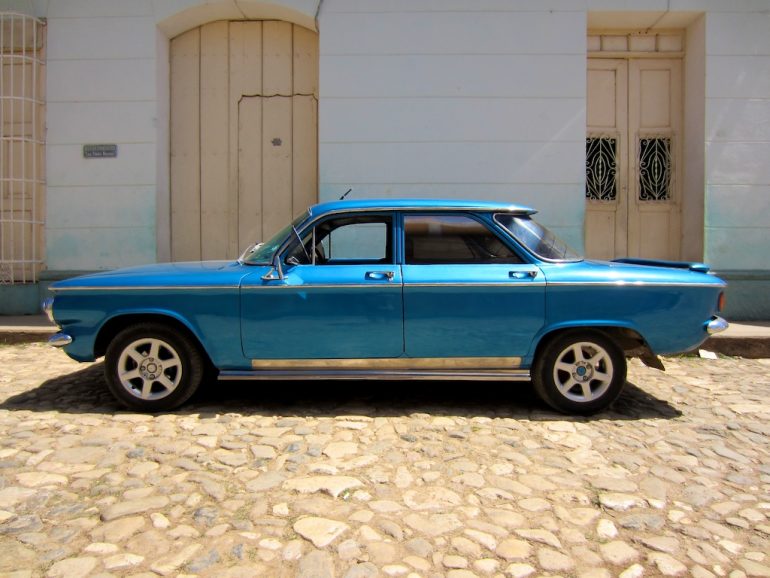 Cuba cars: Blue car in front of building