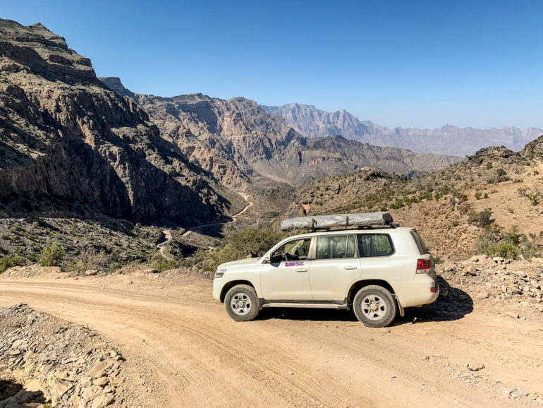 Geländewagen vor Bergkulisse auf einem Oman Roadtrip